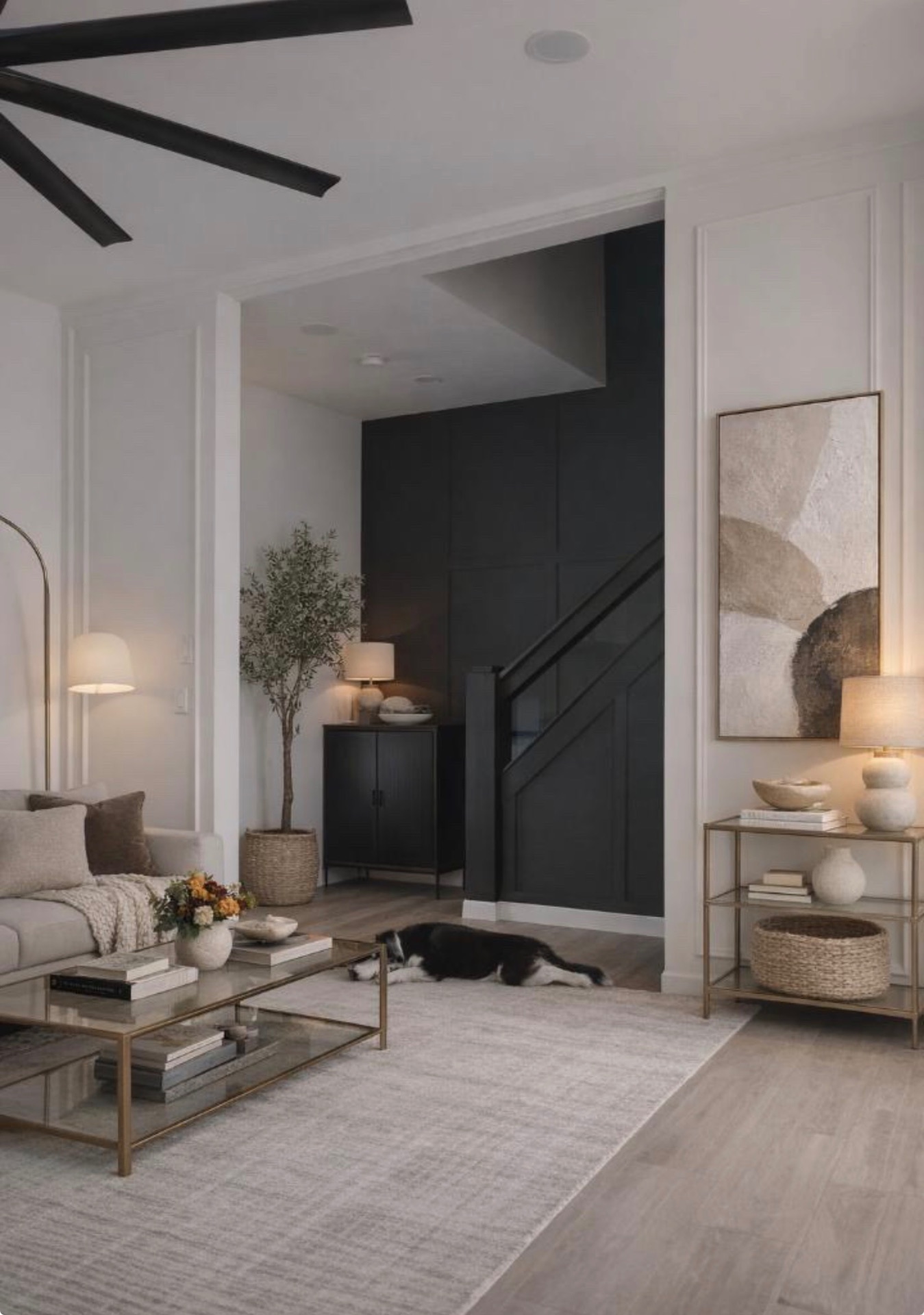 Refined living room with olive tree, curated art and warm lighting by Lux Lustre Homes